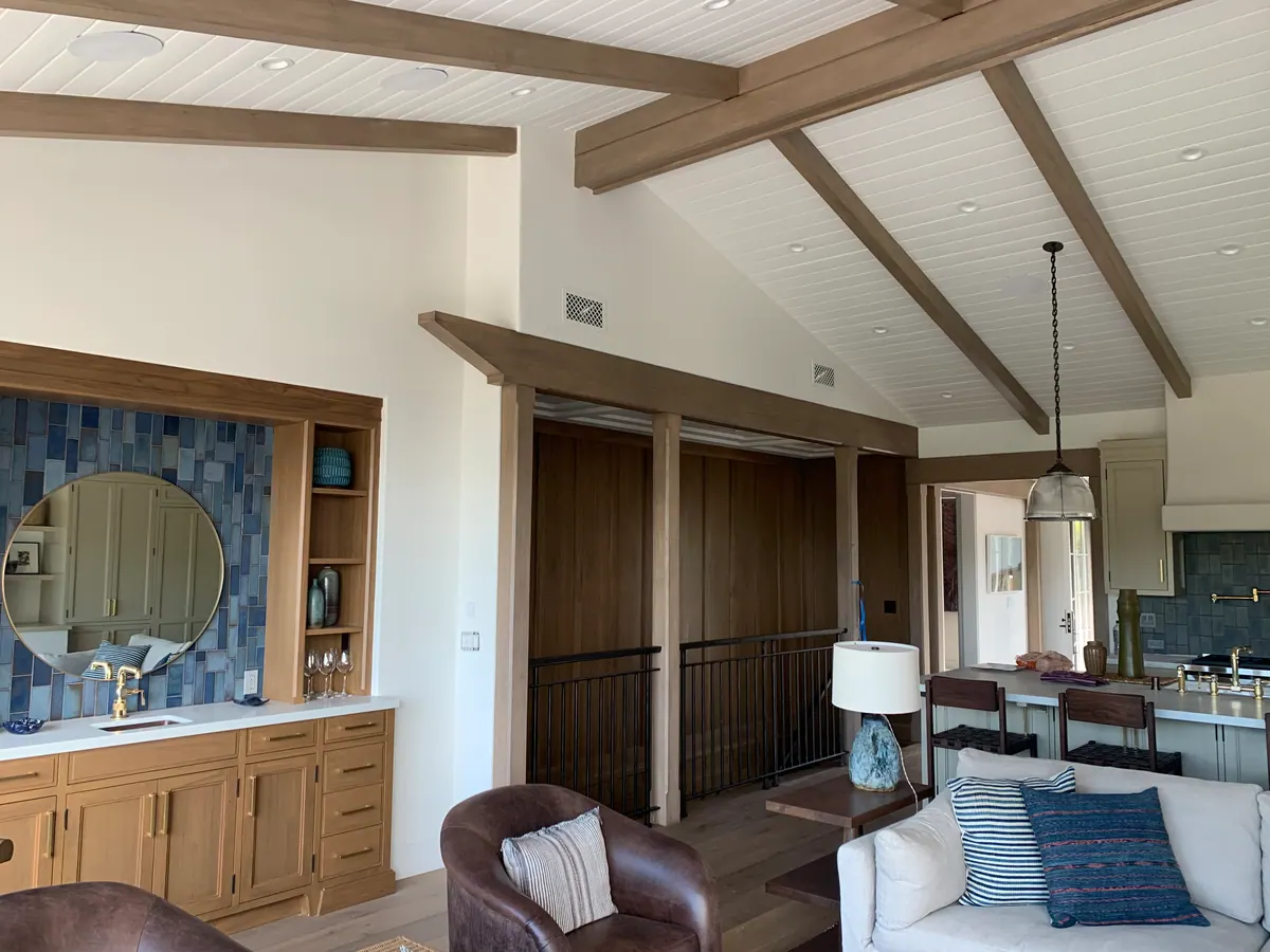 Great room with exposed beams, a blue tile wall bar, and a seating area.