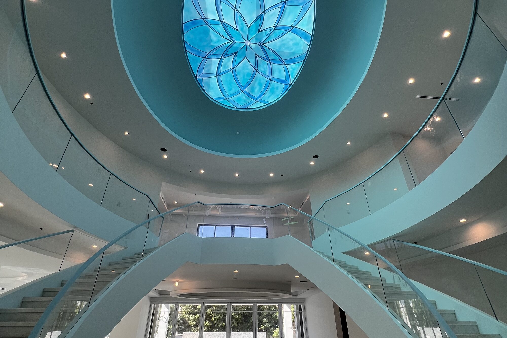 Stair hall with a blue glass skylight.