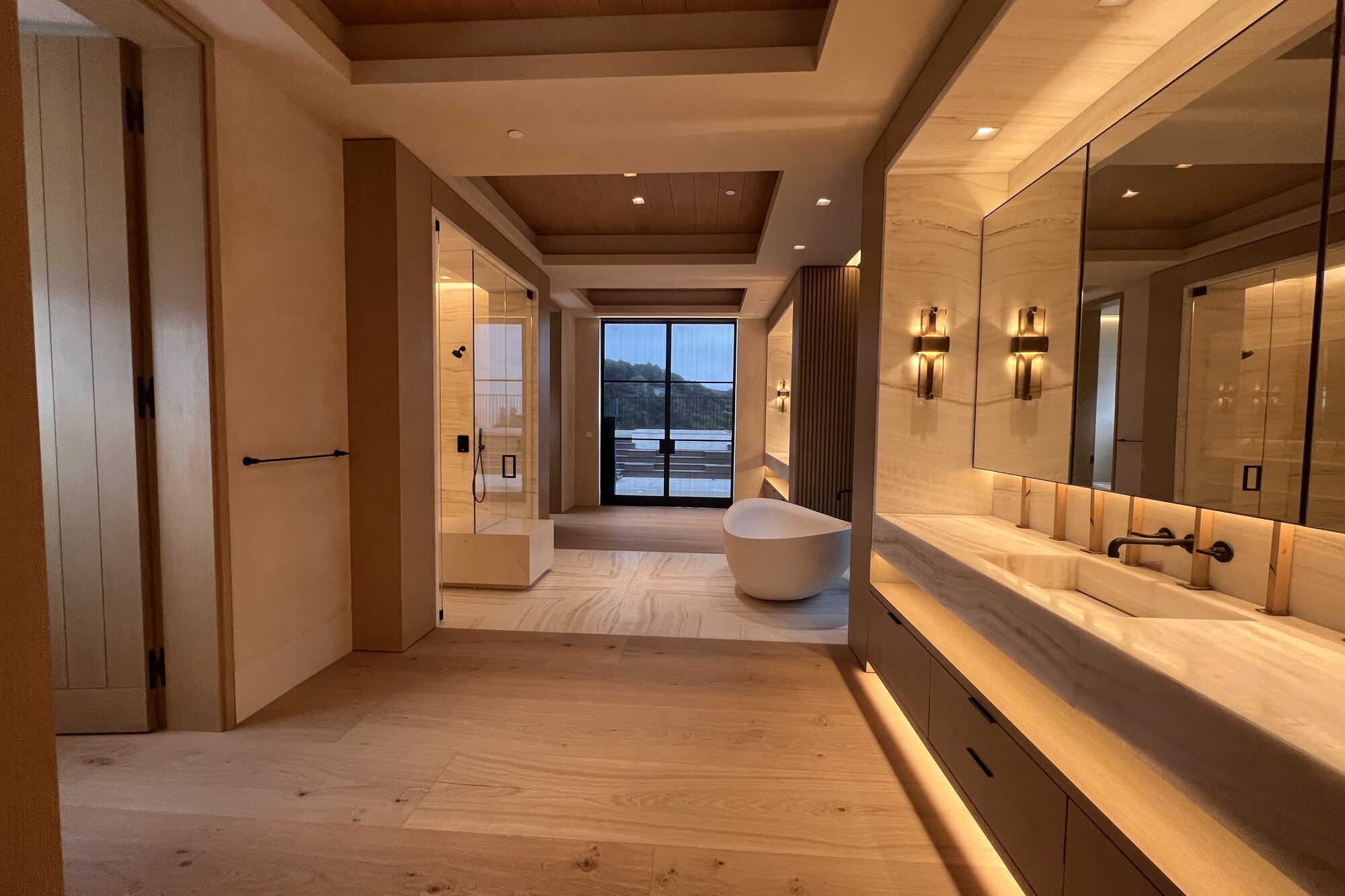 Bathroom with a freestanding tub and a view.