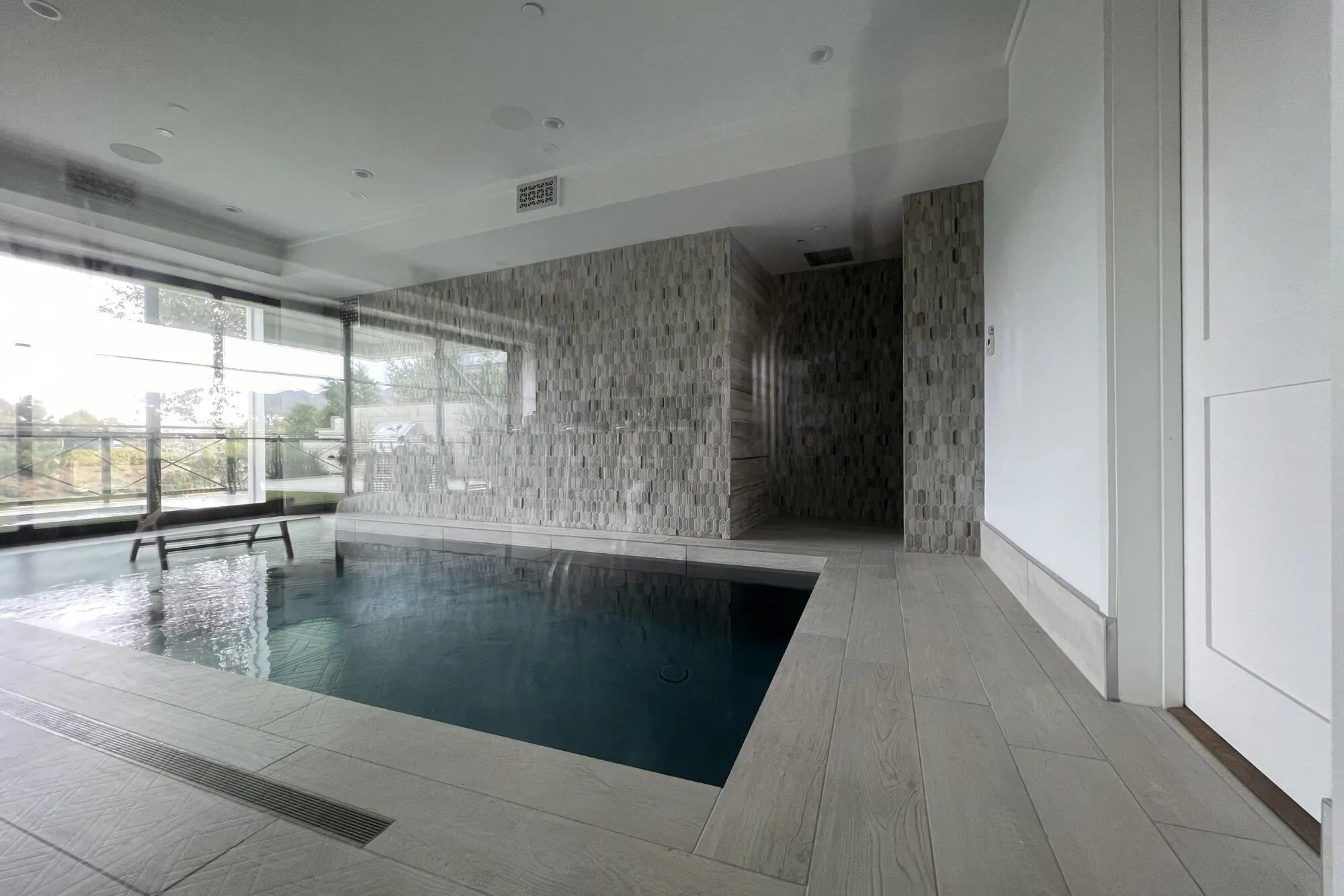 Indoor pool beside a glass wall in Pacific Palisades.